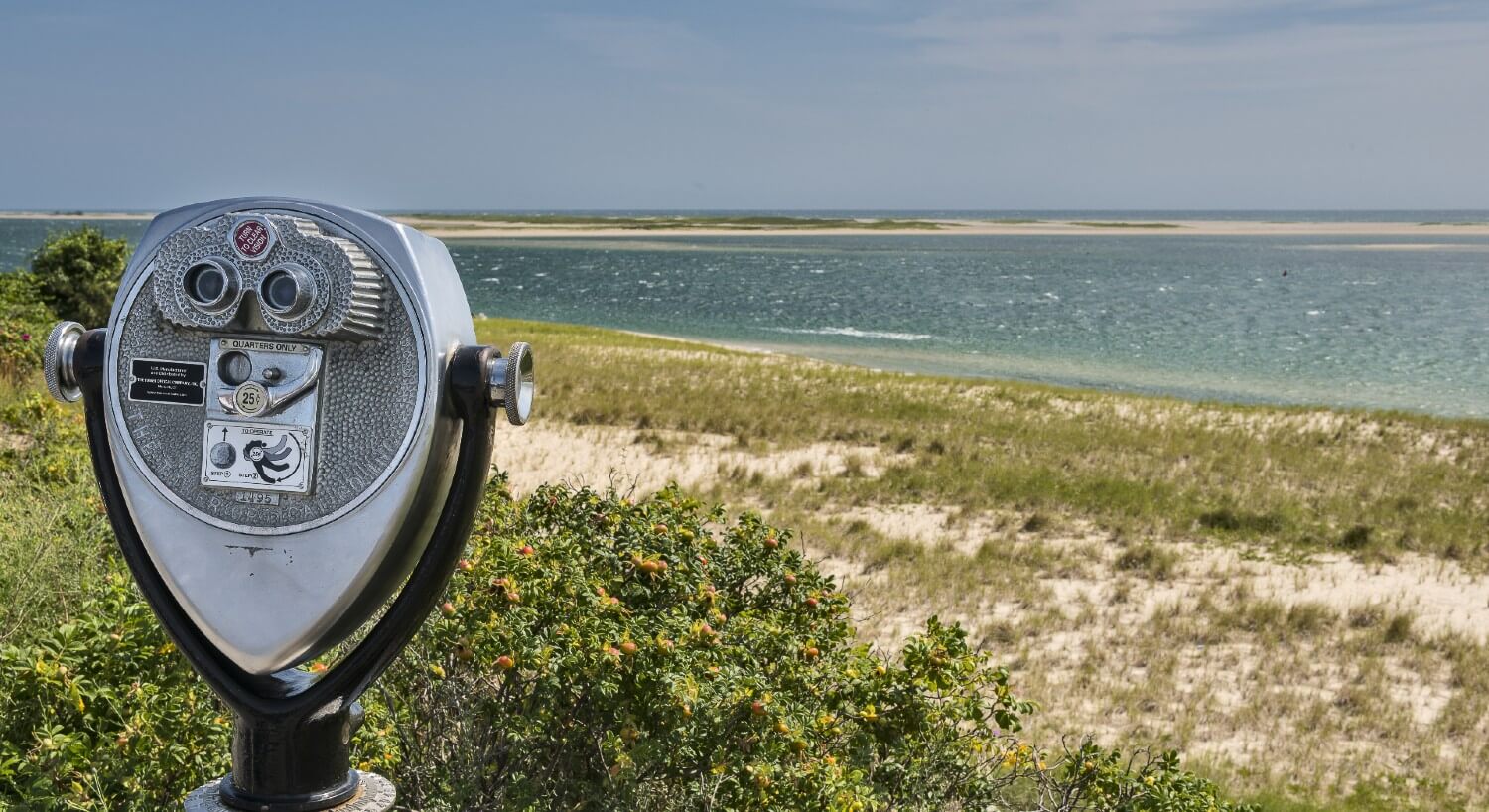 Silver long distance viewer on the beach overlooking the ocean