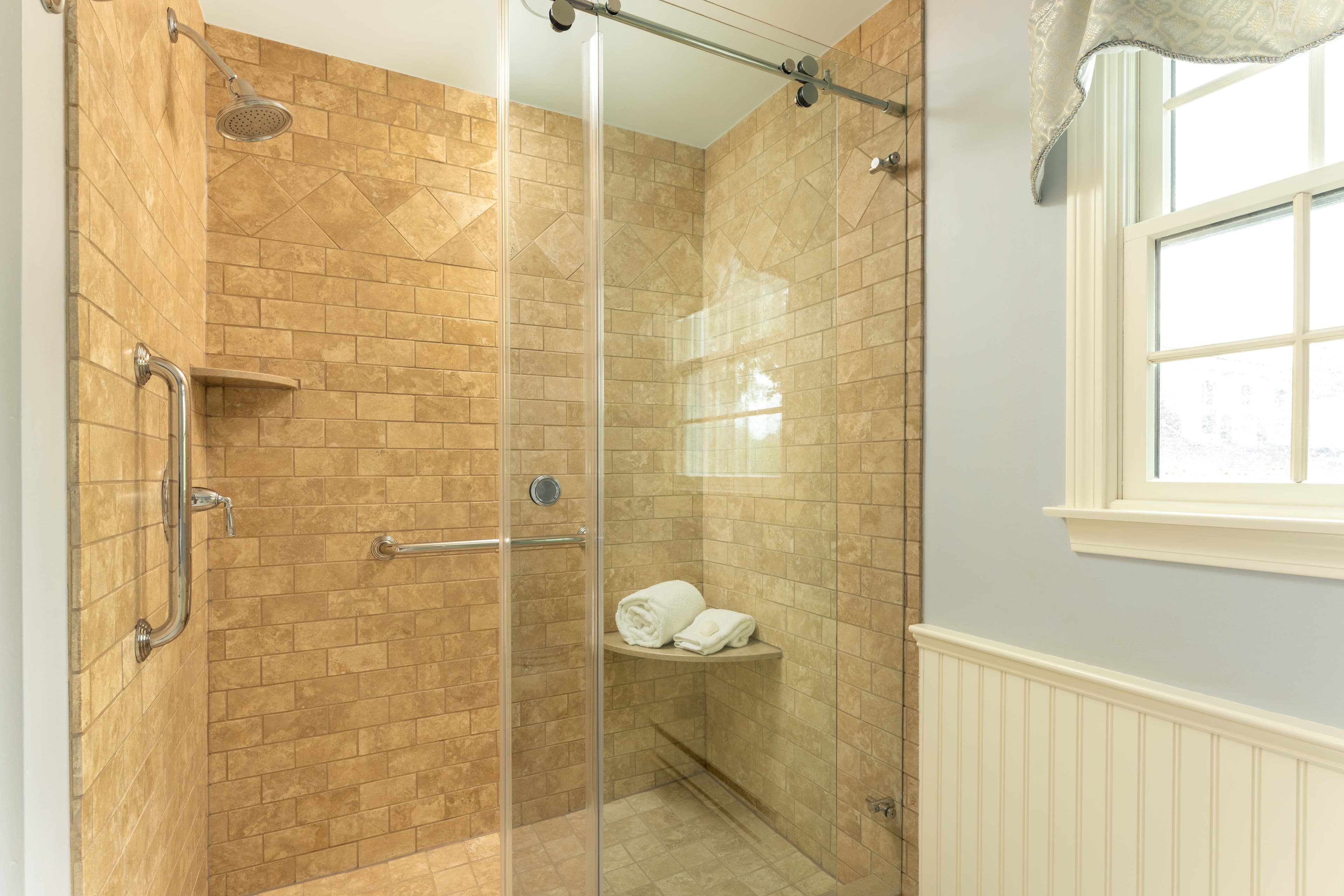 Glass Enclosed Spa shower with brown stone