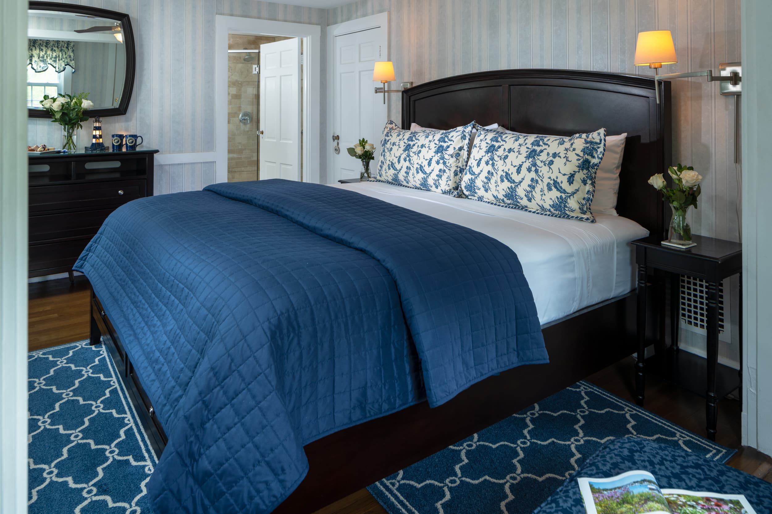 King bedroom Stage Harbor Suite featuring hardwood floors, two bedside tables and four drawer chest