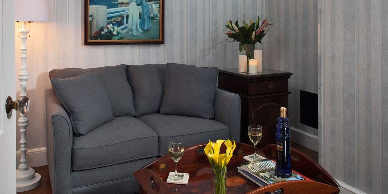 Living Room with small couch, TV and fridge  part of the suite Stage Harbor