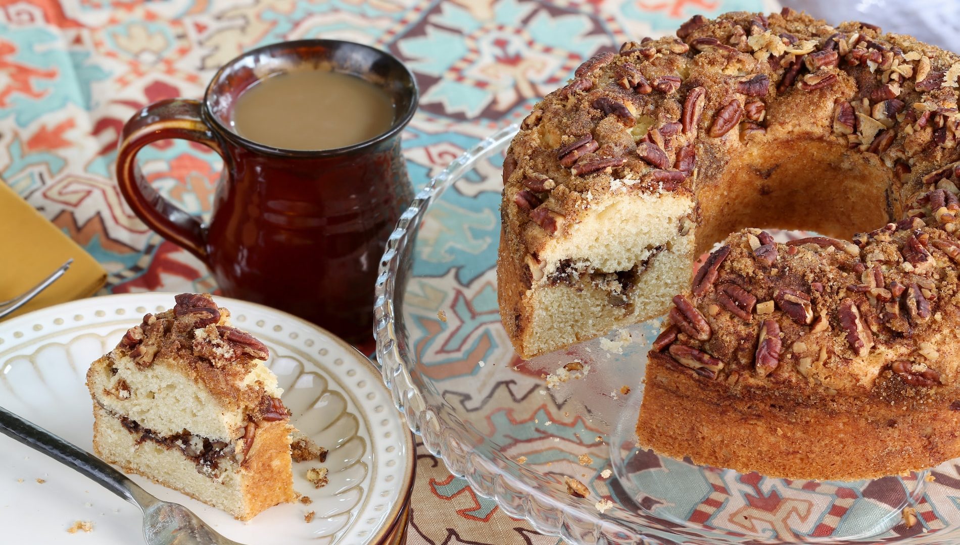 Bundt Cake sprinkled with cinnamon sugar and topped with pecans
