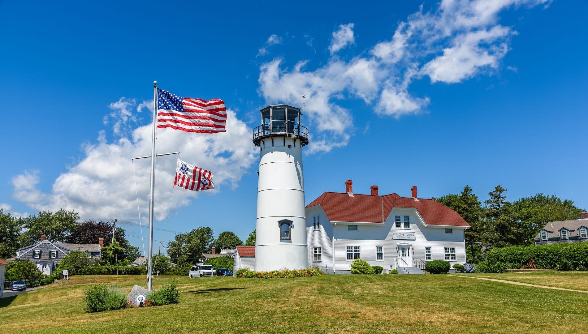 The lighthouse of Chatham and the american flag waving