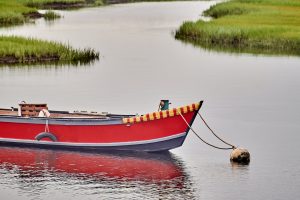 Small red wooden boat moored in Cape Cod, Massachusetts