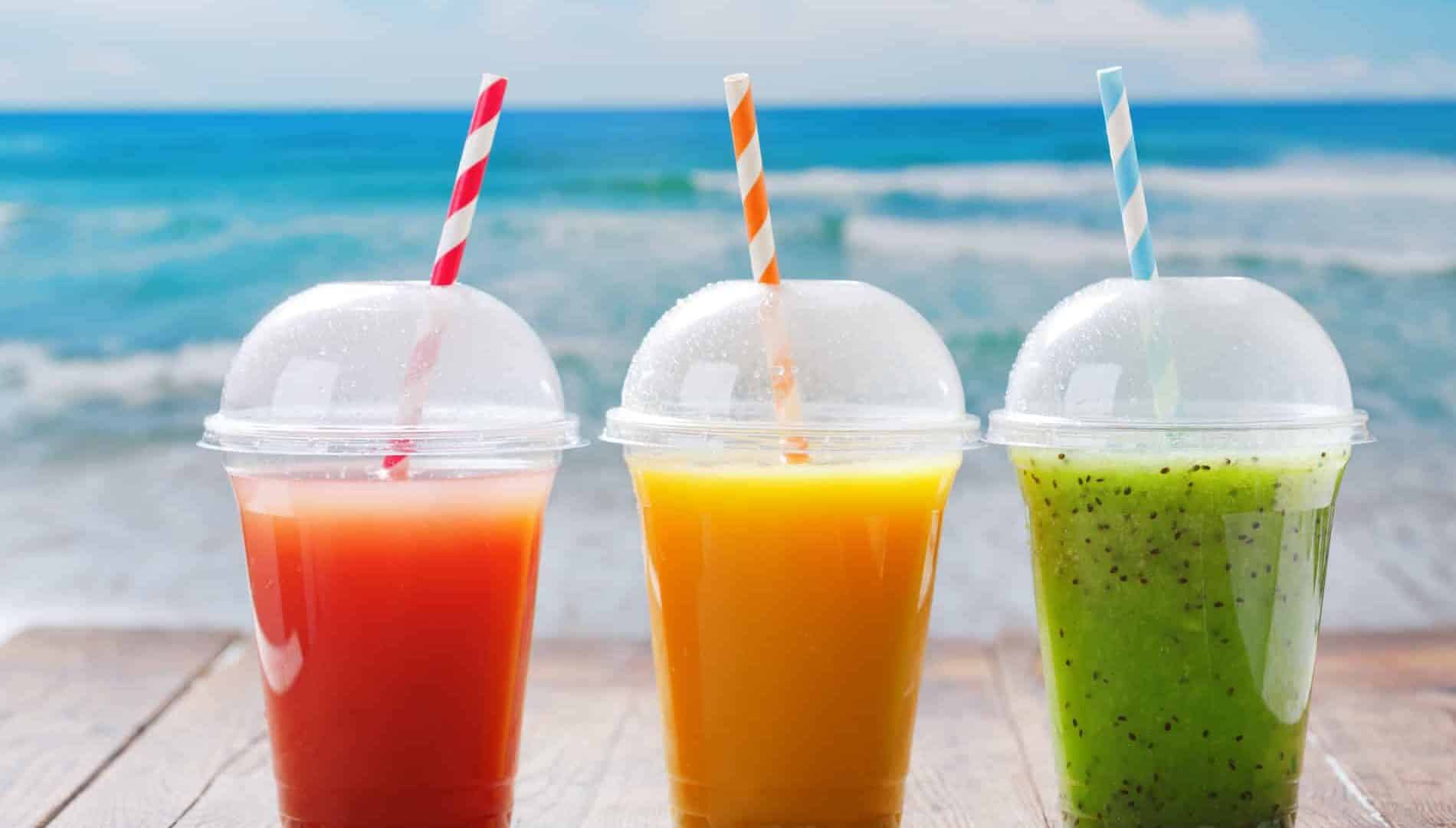 glasses of fruit juice and smoothie on wooden table