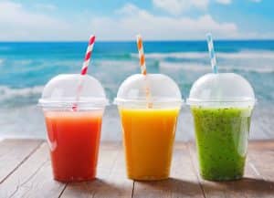 glasses of fruit juice and smoothie on wooden table