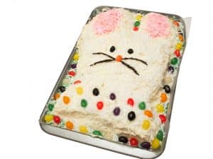 Cut up Bunny cake decorated for Easter with frosting, coconut ,and jelly beans 
