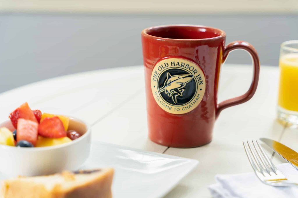 Red mug with a shark logo