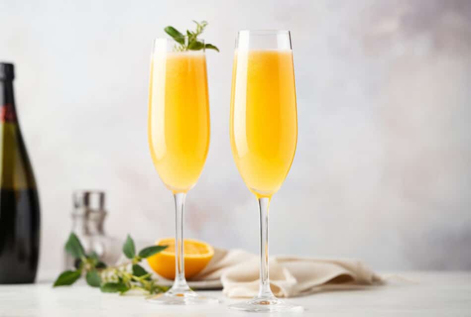 Champagne Glasses filled with Mimosas on a countertop