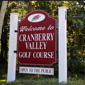 White and red outdoor sign that says Welcome to Cranberry Valley Golf Course Open to the Public