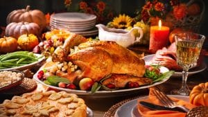 Thanksgiving Dinner roasted turkey, pie, vegetables set on a table